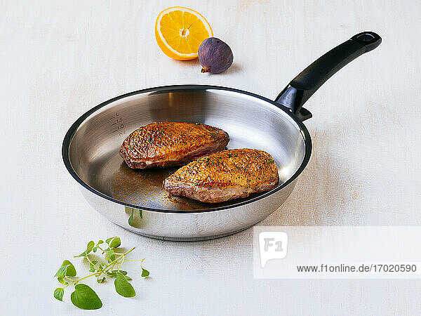 Frying pan with two ready-to-eat duck breasts
