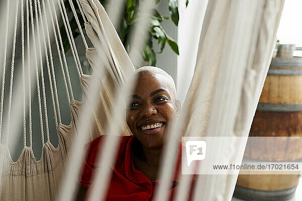 Smiling woman relaxing in hammock