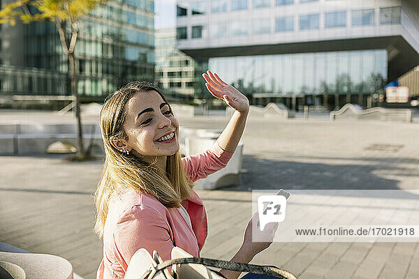 Spain  Barcelona  Smiling woman having video call in city