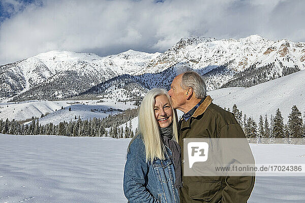 USA  Idaho  Sun Valley  Winter portrait of senior couple in front of Boulder Mountains