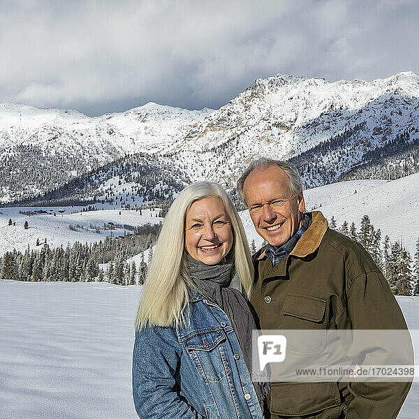 USA  Idaho  Sun Valley  Winter portrait of senior couple in front of Boulder Mountains