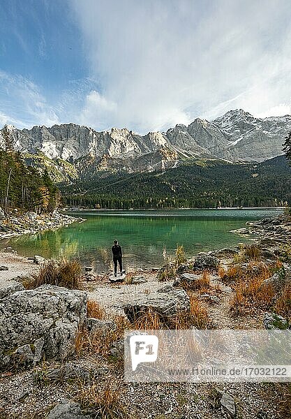 Young woman standing on the shore  Eibsee lake with Zugspitzmassiv and Zugspitze  Wetterstein Mountains  near Grainau  Upper Bavaria  Bavaria  Germany  Europe