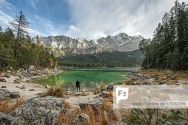 Young woman standing on the shore  Eibsee lake with Zugspitzmassiv and Zugspitze  Wetterstein Mountains  near Grainau  Upper Bavaria  Bavaria  Germany  Europe
