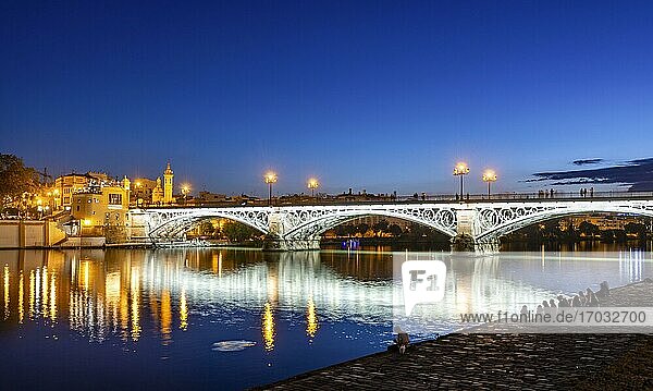 Illuminated bridge Puente de Triana over the river Rio Guadalquivir  blue hour  Sevilla  Andalusia  Spain  Europe