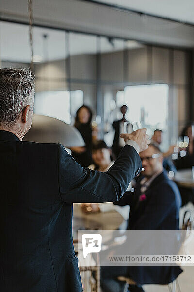 Businessman with wineglass during office party
