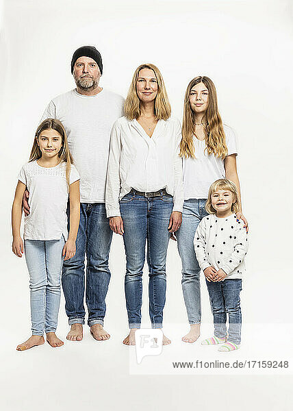 Happy family against white background in studio