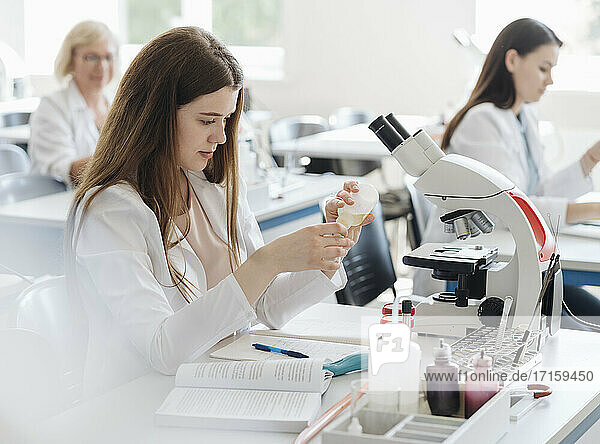 Researchers in white coats working in lab