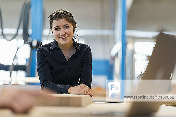Smiling businesswoman working with colleague at industry