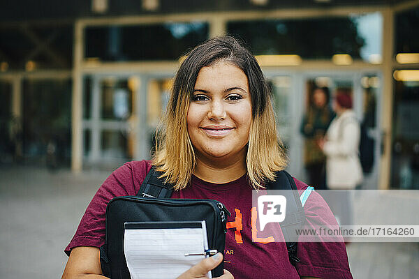 Portrait of smiling female student in college campus