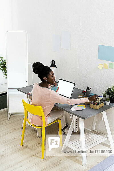 Fashion designer working while sitting at home office