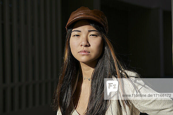 Young woman with brown cap during sunny day