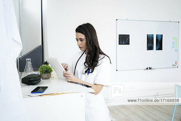 Female doctor using digital tablet at clinic