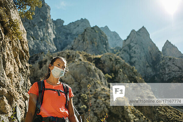 Hiker wearing face mask while hiking on mountain at Cares Trail in Picos De Europe National Park  Asturias  Spain