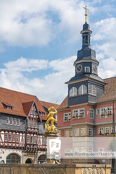 St. George Fountain by church amidst historic houses in Market Square at Eisenach  Germany