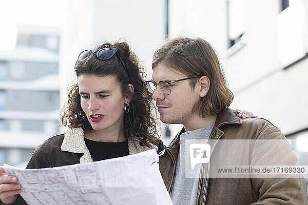 Young couple examining blueprint