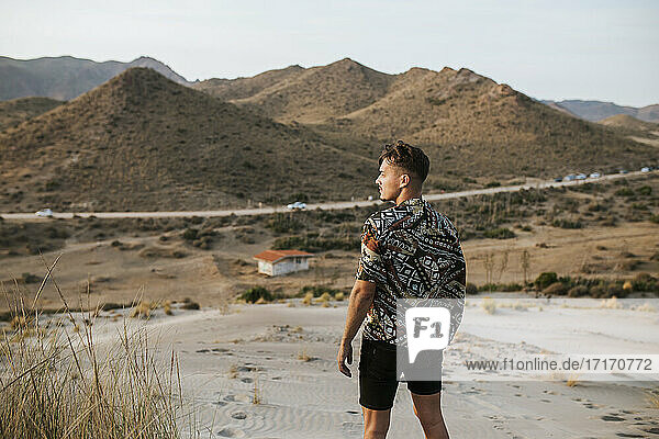 Junger Mann steht in der Wüste von Almeria  Tabernas  Spanien
