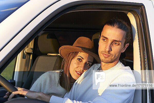Woman embracing boyfriend while sitting in car