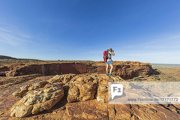 Female hiker photographing landscape of Kings Canyon