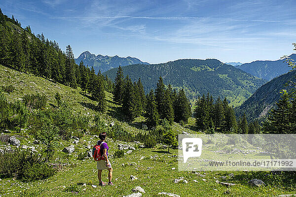 Mature hiker looking view while standing on Schellenberg-Alm mountain at Bavaria  Germany