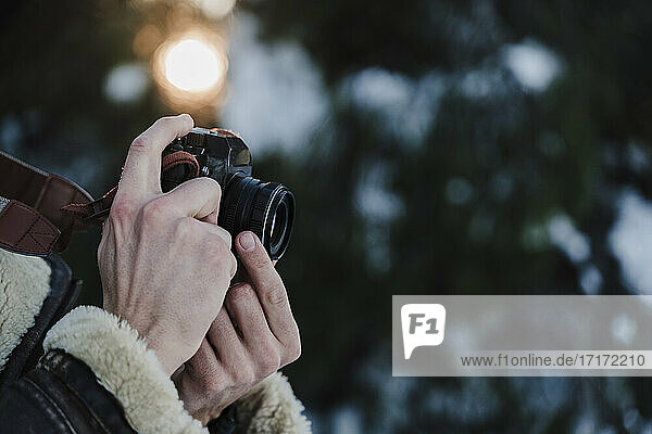 Man taking pictures with camera during winter