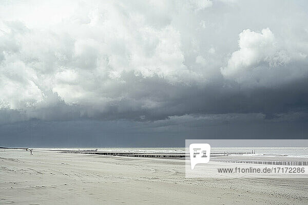 Storm clouds over empty coastal beach