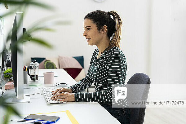 Creative businesswoman working on computer at desk in office