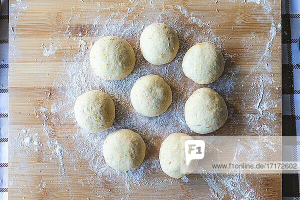 Croissants dough balls on cutting board