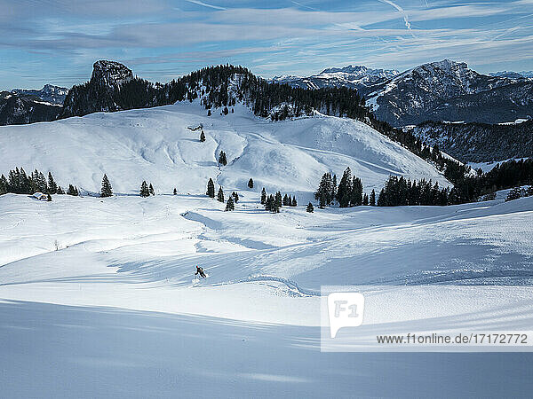 Man skiing on snow covered Karkopf  Lattengeburge  Berchtesgadenerland  Germany