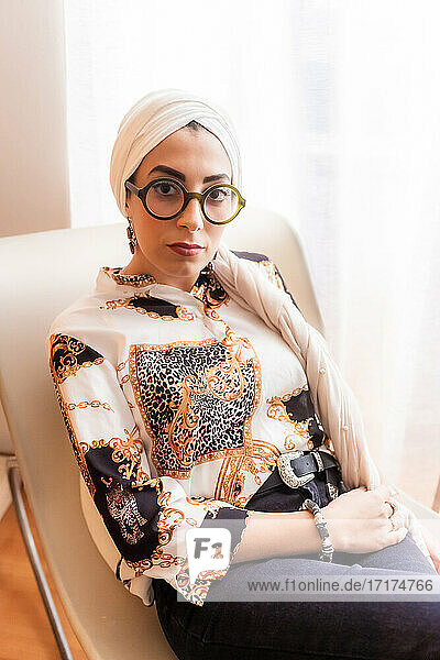Portrait of stylish woman wearing hijab and glasses