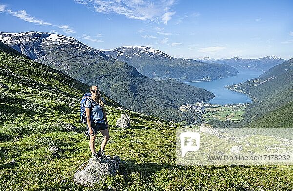 Hiker on the trail to Skåla mountain  Innvikfjorden fjord  Jostedalsbreen National Park  Stryn  Vestland  Norway  Europe