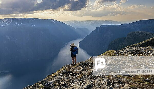 Hiker  evening mood at the top of the mountain Prest  fjord Aurlandsfjord  Aurland  Norway  Europe