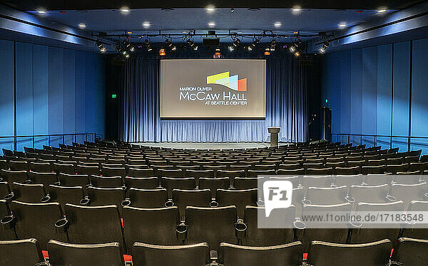 Empty auditorium, rows of raked seats.