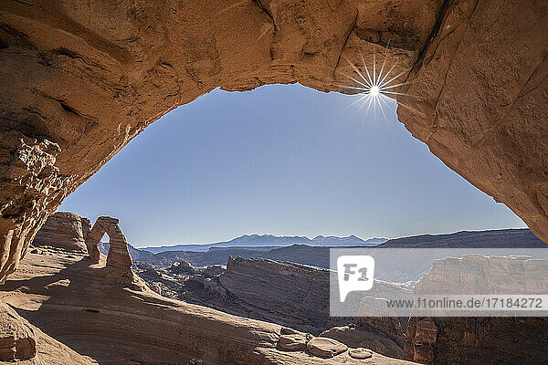Blick auf Delicate Arch durch Frame Arch mit Sonnenaufgang  Arches National Park  Utah  Vereinigte Staaten von Amerika  Nordamerika