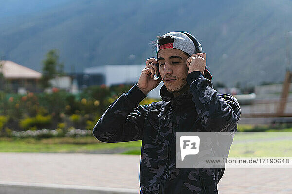 Young man listening to music for exercise.