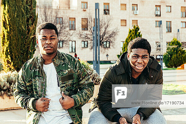 Portrait of two African-American friends smiling and having fun in an urban space.