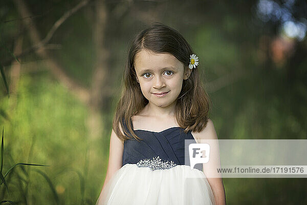 Niedliches kleines Mädchen im weißen Kleid im Freien.