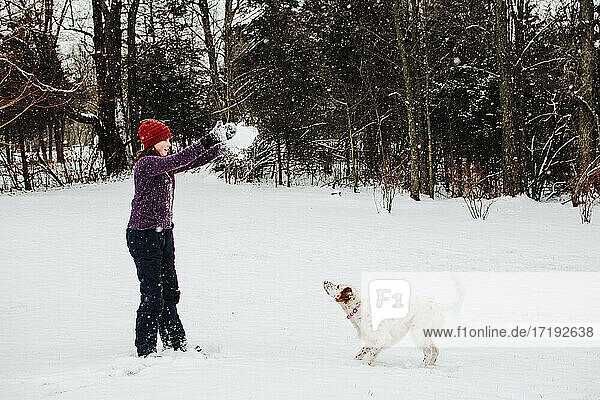 Girl playing in the Snow with her Dog in Southern Michigan