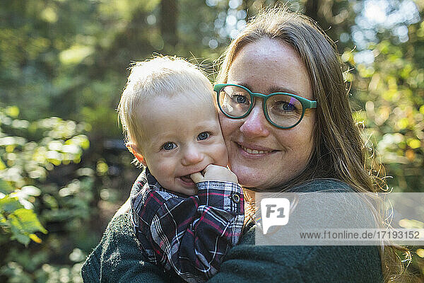 Outdoor portrait of a mother holding her one year old son.
