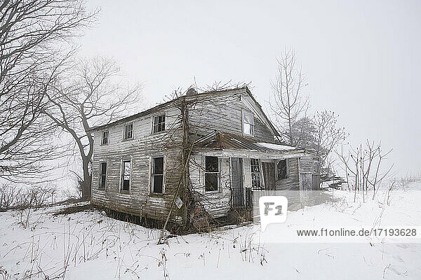 Verlassenes Bauernhaus im nebligen kanadischen Winter