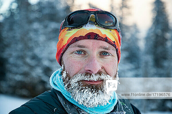man in extreme weather in winter mountains