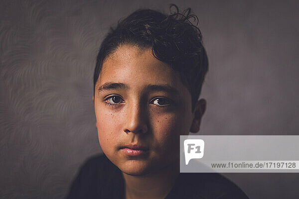 Simple portrait of a boy looking serious.