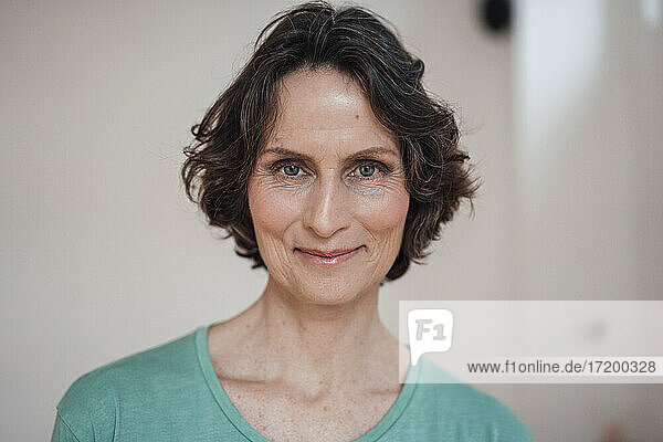 Smiling mature woman at home office