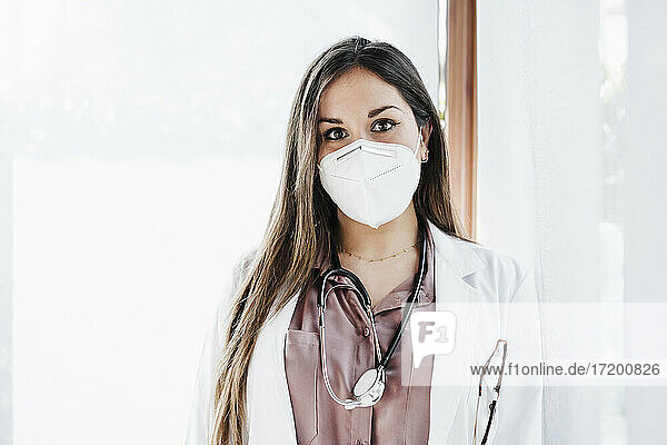 Female doctor with protective face mask in hospital