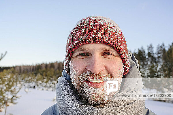 Mid adult man face covered in snow during winter