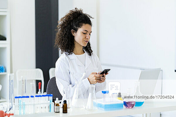 Junge Forscherin benutzt Smartphone in der Klinik