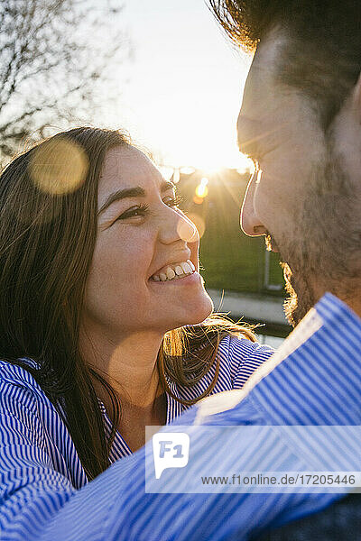 Smiling mid adult couple looking at each other during sunset