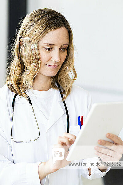 Female doctor using digital tablet at medical clinic