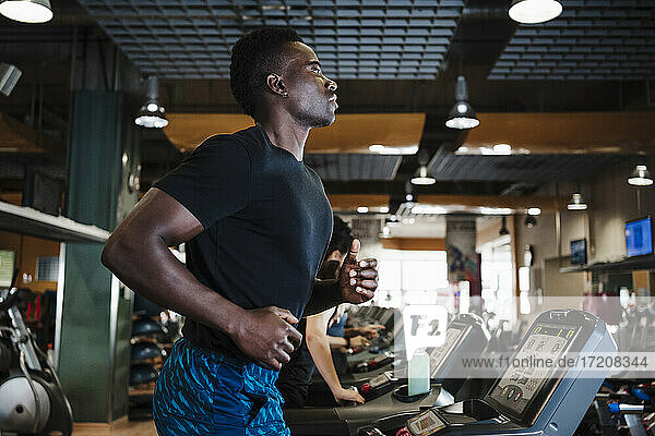 Man running on treadmill in gym