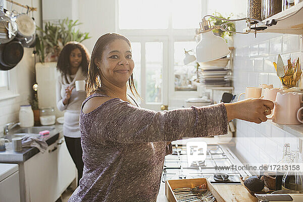 Portrait happy woman in apartment kitchen