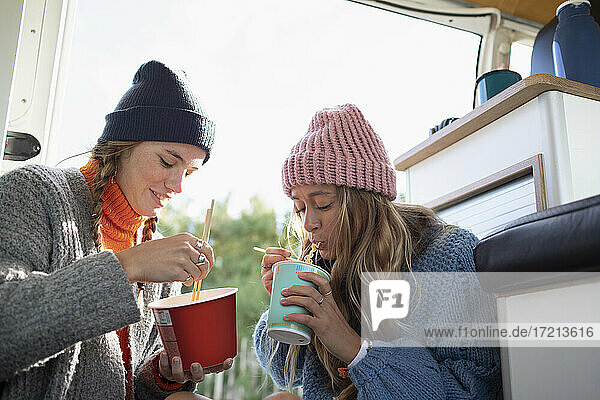 Junge Frauen Freunde essen Instant-Nudeln im Wohnmobil